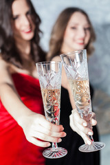 elegant young womans with champagne glasses at celebration