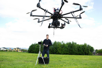 Male Technician Flying UAV Octocopter