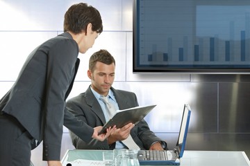 Young colleagues consulting at meeting