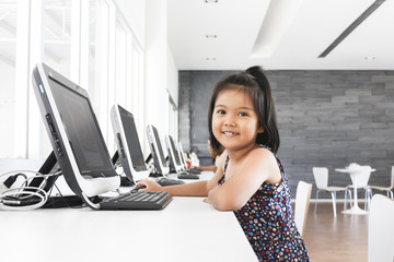 Little girl playing computer