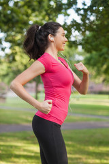 Happy sporty woman jogging in a park