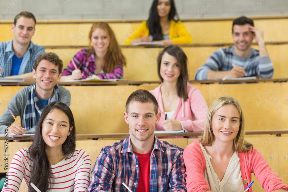 Poster smiling students sitting at the lecture hall
