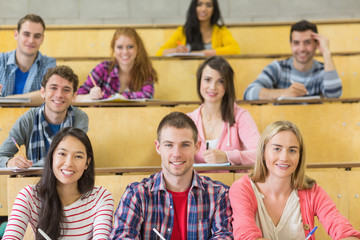 Smiling students sitting at the lecture hall