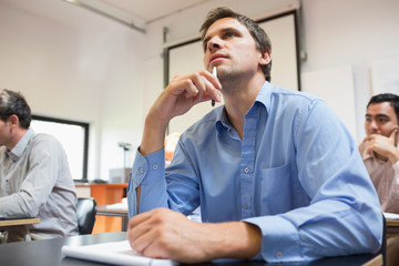 Mature students taking notes in classroom