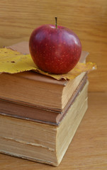 Red apple on old books