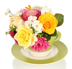 Beautiful bouquet of bright flowers in color mug, isolated
