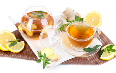 Kettle and cup of tea with ginger on napkin isolated on white
