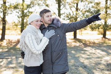 Loving young couple in winter clothing in the woods