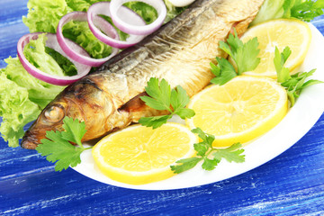 Smoked fish on plate close up