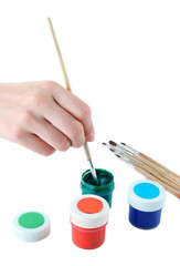 Paint brushes and multicolored paints isolated on white