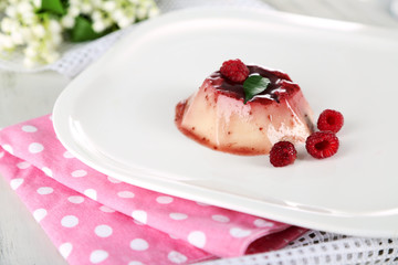 Panna Cotta with raspberry sauce, on wooden background