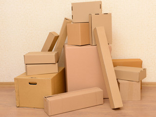 Empty room with stack of cartons: moving house concept