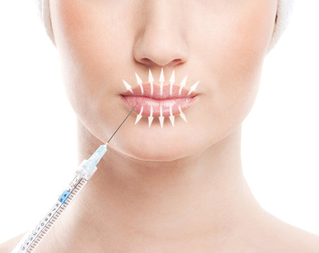 Beautiful face and the syringe (plastic surgery concept)