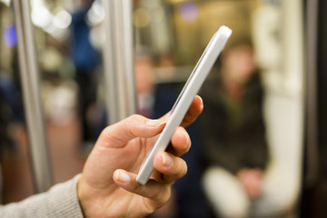Woman using her cell phone in Subway