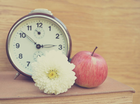 Vintage old clock and apple