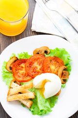 Light breakfast with soft egg, tomato and croutons