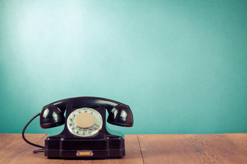 Retro rotary telephone in front mint green wall