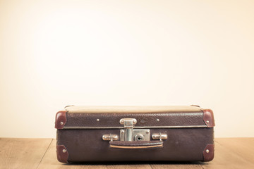 Vintage old travel suitcase on floor with empty space for text
