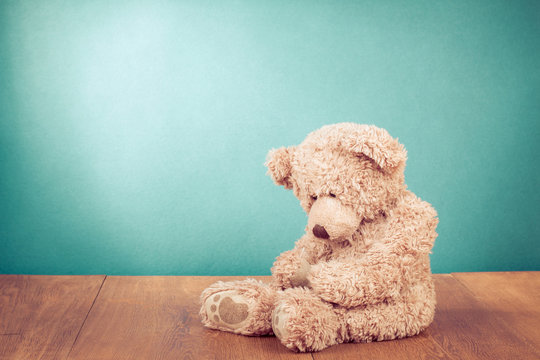 Teddy Bear toy alone in front mint green background