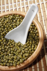mung beans in bowl with ceramic spoon