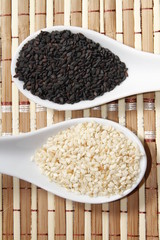 black and white sesame seeds on ceramic spoon
