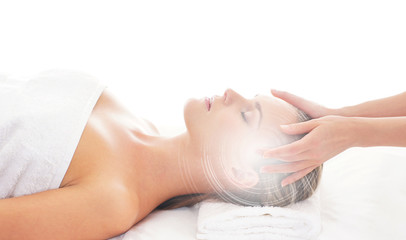 An attractive woman getting spa treatment on a white background