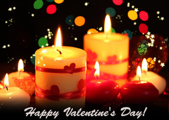 Beautiful candles on wooden table on bright background