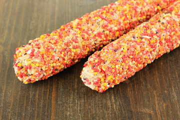 Food for parrots on wooden background