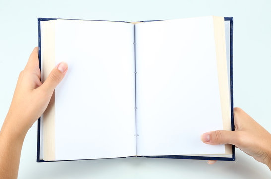 Book in hands isolated on white