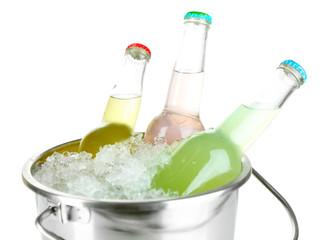 Bottled drinks in ice bucket isolated on white