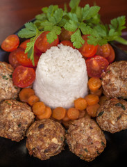 meatballs served with rice and freash vegetables