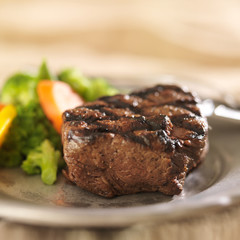 grilled steak on plate with vegetables