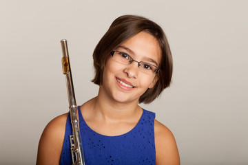 Young Girl Playing a Flute © kmlPhoto