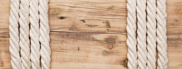Fototapeta premium frame made of rope on a wooden background
