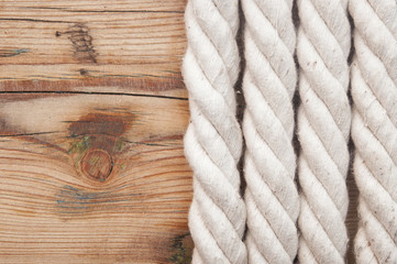 Fototapeta na wymiar White rope on old wooden background