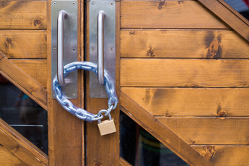 Brass iron lock and chain on wood door