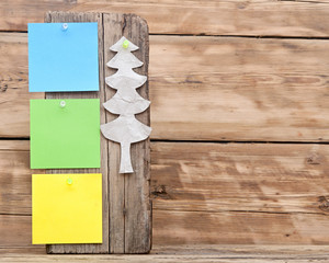 colorful reminder notes attached on a old wooden signboard with