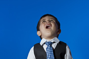 Leader, cute little boy portrait over blue chroma background