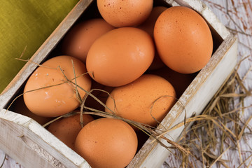 Chicken eggs on wooden background