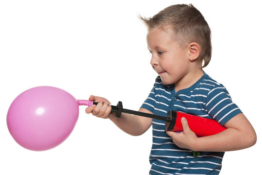 Little boy inflates a balloon
