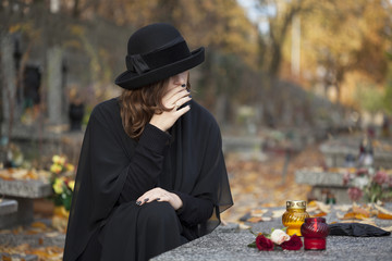 Grieving woman at graveyard