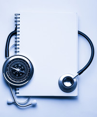 Stethoscope, compass and notebook