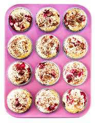 Muffins with Chocolade and Cherry in a pink colored baking tray