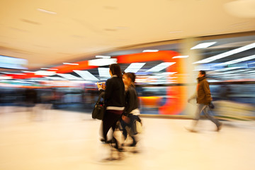 A shopper walking in front of shop window