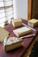 Variety of cheese on wooden board buffet line