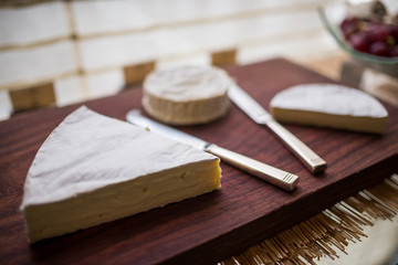 Fototapeta na wymiar Variety of cheese on wooden board buffet line