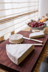 Variety of cheese on wooden board buffet line