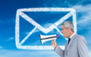 Composite image of businessman shouting in loudspeaker