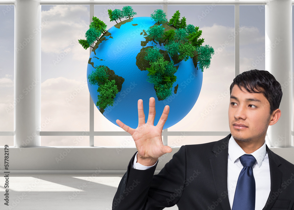 Poster Composite image of unsmiling businessman holding and pointing