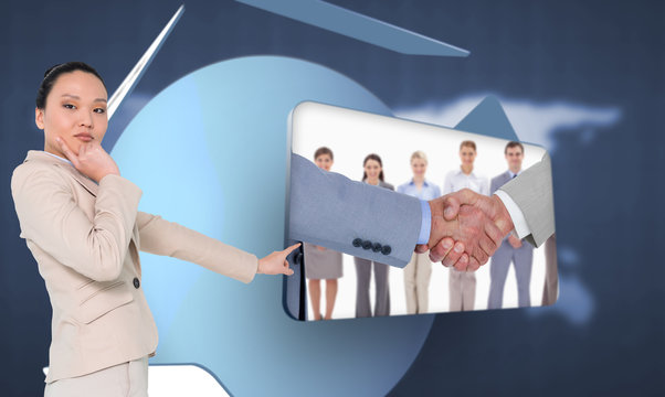Composite image of thoughtful asian businesswoman pointing